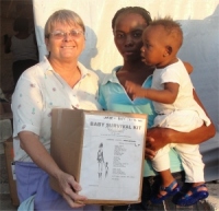 Jenny Tryhane Founder UCT seen here distributing the Baby Survival Kits in Haiti.
