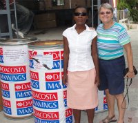 Seen here the President of the Association who is blind with Jenny Tryhane Founder of UCT in Haiti handing over the donation.
