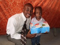 Daniel Noel distributed Make Jesus Smile shoeboxes at the Nazarene church in Goniave on Sunday morning.