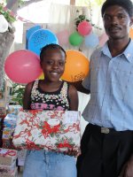 Seen here a child at YWAM in Goniave, in the north of Haiti, receiving her St Gabriel's shoebox shortly after the earthquake