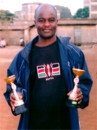 Seen here Rev Kennedy Salano in his Kenyan football shirt holding the trophies.