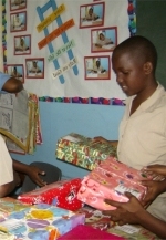 Make Jesus Smile shoeboxes being filled by a Barbadian school boy