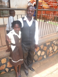 Daphine seen here with her new dad - Pastor Abraham on her first day at school - praise God.