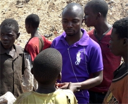 Pastor Abraham, seen here in the centre of the street children on one of the rubbish dumps in Kampala
