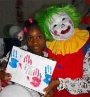 Annie the clown distributing Make Jesus Smile shoeboxes