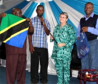 Jenny receiving her gifts including a flag of Tanzania from Bishop and Pastor David and the KIMI Dar Es Salaam coordinator - Pastor Imanuel Mwamakola seen here on the right.