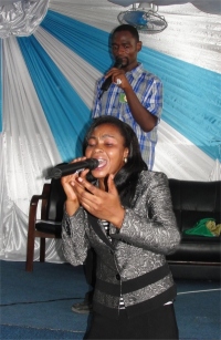 Seen here with Pastor David behind her leading worship
