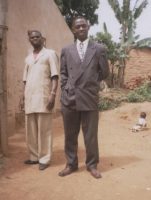 Pastor Israel Siame on the door of the church, in black suit is Pastor Lotie. in Zambia