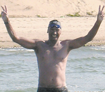 Chris Gibbs celebrating at the end of his record swim across the English Channel yesterday