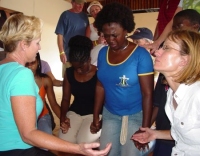 Heidi Baker praying with Marcia Weeks from Praise Academy in Barbados