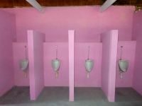 There are 4 urinals as well as as 4 toilets.