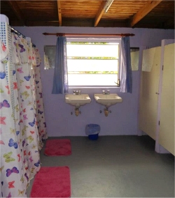 The bathroom has 4 toilets and 4 showers and has been recently tiled and upgraded.
