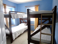 The west facing bedroom has two bunk beds and a chest of drawers. 
