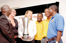 Digicel group sponsorship director Marguerite Cremin (with cup) seems to be asking Barbados’ footballers
