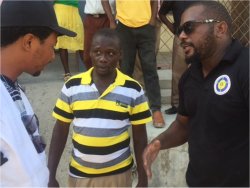 The leader in Jeremie receiving information from Imran being translated by a member of the Haitian team.