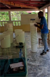 Seen here the team preparing the 5 gal buckets prior to the first distribution.