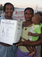 Seen here Dr. Yolader Thervil better known as Mama Yol helping with the distribution at a tent city