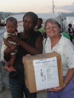 Jenny Tryhane, Founder of UCT in Haiti distributing a box in one of the tent cities.