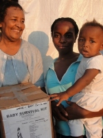 Seen here Dr. Yolader Thervil better known as Mama Yol helping with the distribution at a tent city