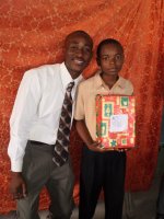 Daniel Noel distributed Make Jesus Smile shoeboxes at the Nazarene church in Goniave on Sunday morning.