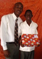 Daniel Noel distributed Make Jesus Smile shoeboxes at the Nazarene church in Goniave on Sunday morning.