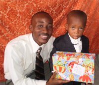 Daniel Noel distributed Make Jesus Smile shoeboxes at the Nazarene church in Goniave on Sunday morning.