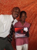 Daniel Noel distributed Make Jesus Smile shoeboxes at the Nazarene church in Goniave on Sunday morning.