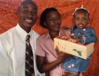 Daniel Noel distributed Make Jesus Smile shoeboxes at the Nazarene church in Goniave on Sunday morning.