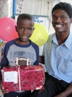 Seen here a little boy with Pastor Bannes the Kids' Evangelism Explosion Haiti Director receiving his gift.