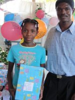 Kids' EE Haiti director distributing Make Jesus Smile shoeboxes