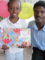 Kids' EE Haiti director distributing Make Jesus Smile shoeboxes