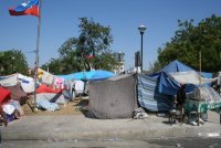 Most people in Port au Prince continue to sleep under tents, tarps or sheets.