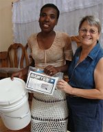 Seen here Jenny, founder of United Caribbean Trust at the Yolanda Thervil Foundatoin, Bon Repos helping Pastor Banes with the filter distribution.