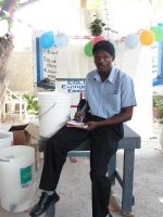 Pastor Pierre Banes Laurore, the Kids' EE Haiti Director seen here in YWAM in Gonaive documenting the Sawyer PointONE water filter distribution.