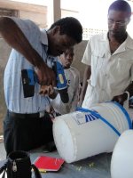 Seen here Pastor Banes setting up a filter at the YWAM distribution in Goniave.