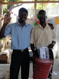 Pastor Pierre Banes Laurore, the Kids' EE Haiti Director seen here in YWAM in Gonaive documenting the Sawyer PointONE water filter distribution.