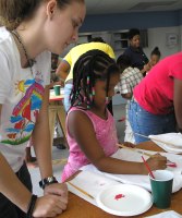 Seen below the children of Barbados hand-painting the Kisses from Heaven tee shirts