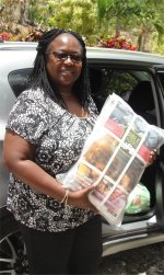 Rev Sonia Hamilton Cutting from 'Living 
                    Hope Ministries' in the Pine Community receiving Love Packages donated to Mount Zion Missin International church