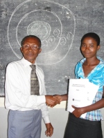 Pastor Sam the Karunga Coordinator distrbuting KIMI curriculums