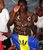 PowerClub leaders praying over the flag of Barbados,