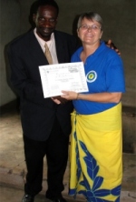 Pastor William seen below right receiving his certificate from Jenny his teacher. 