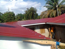 The beautiful red galvanized roof is now on.