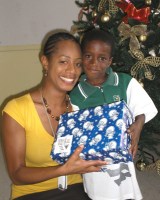 Seen here the children receiving their Make Jesus Smile Christmas shoebox gifts packed by the children of Barbados.