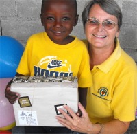 Seen here Jenny Tryhane, the Founder of United Caribbean Trust distributing the Make Jesus Smile shoeboxes at Upper Room Orphanage. 