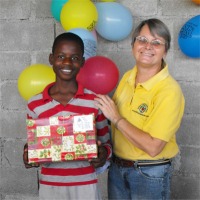 Seen here Jenny Tryhane, the Founder of United Caribbean Trust distributing the Make Jesus Smile shoeboxes at Upper Room Orphanage.