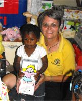 Jenny Tryhane, Founder of United Caribbean Trust giving out the first shoeboxes only hours after the container had been released.