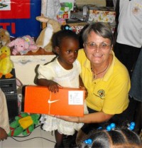 Jenny Tryhane, Founder of United Caribbean Trust giving out the first shoeboxes only hours after the container had been released.