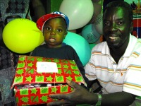 YWAM Director Muala Jean-Marie and below his wife assisting with the distribution.