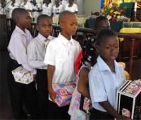 Seen here at their Harvest Festival bearing their Make Jesus Smile shoebox gifts as they brought them to the alter to 'Sow a seed of Love' for Haiti.