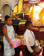 Seen here at their Harvest Festival bearing their Make Jesus Smile shoebox gifts as they brought them to the alter to 'Sow a seed of Love' for Haiti.